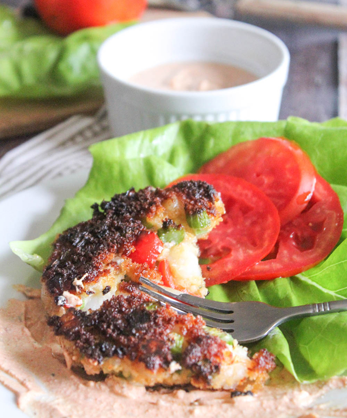 a close up of a cooked shrimp cake on a plate with a fork