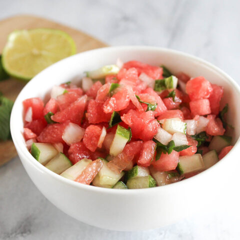 a close up of the finihsed salsa in a white bowl