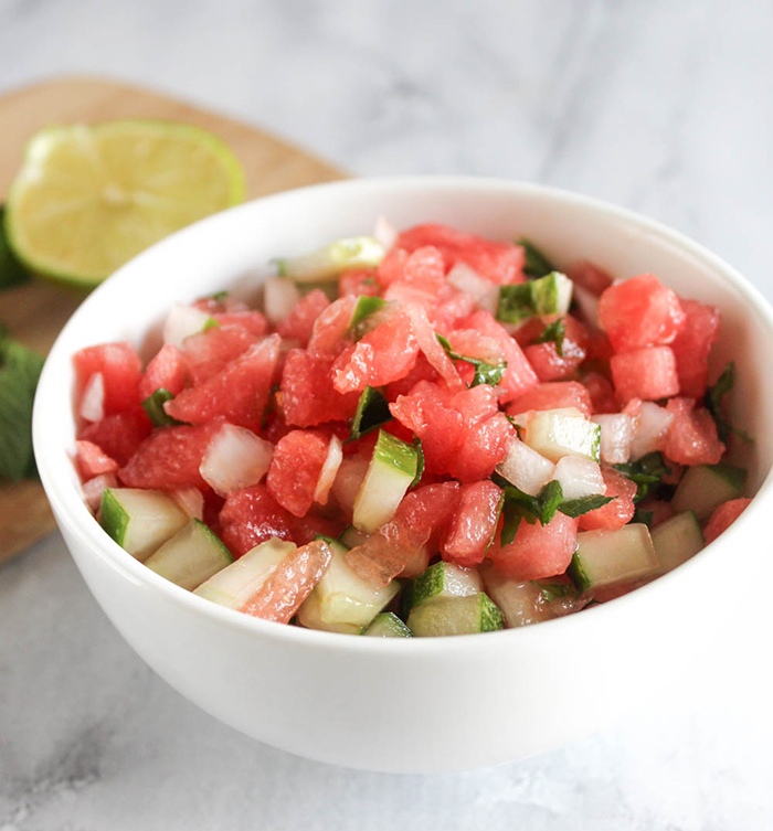 a close up of the finished salsa in a white bowl