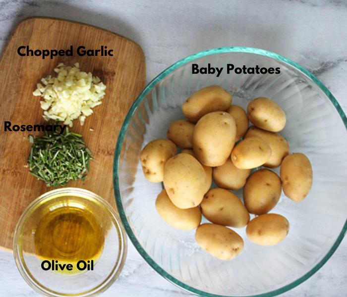 The ingredients: chopped garlic, rosemary olive oil and baby potatoes