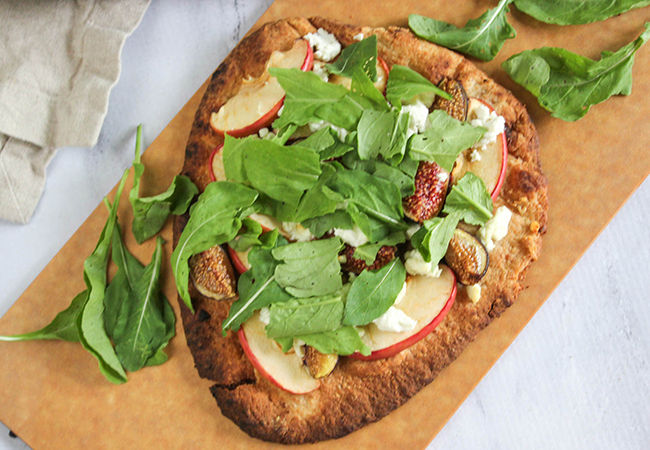 a picture of the fig flatbread toped with arugula