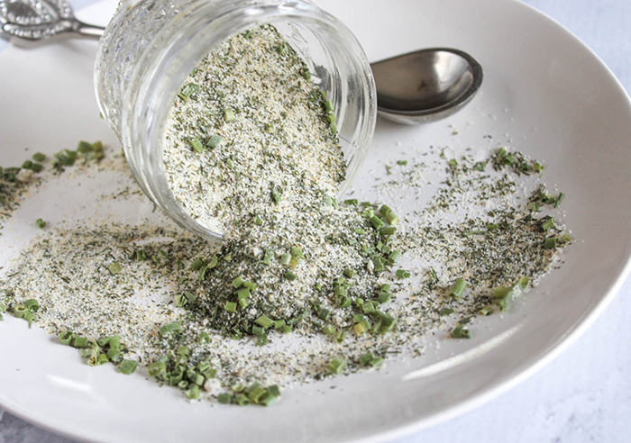 ranch season pouring out of a jar onto a white plate