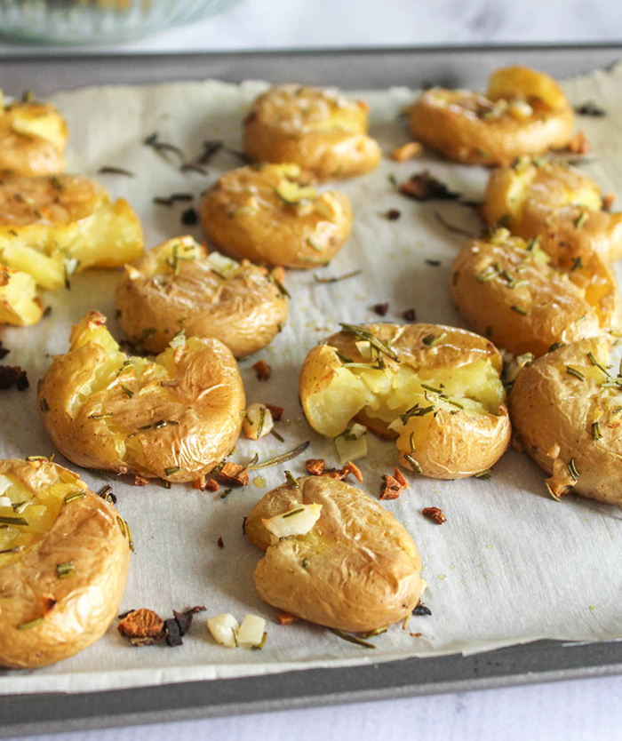 smashed potatoes on a baking sheet