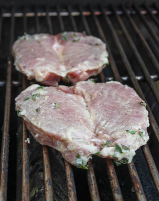 pork chops cooking on the grill