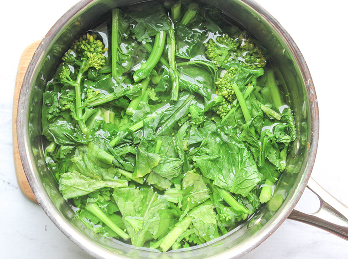 broccoli rabe in a pan with water