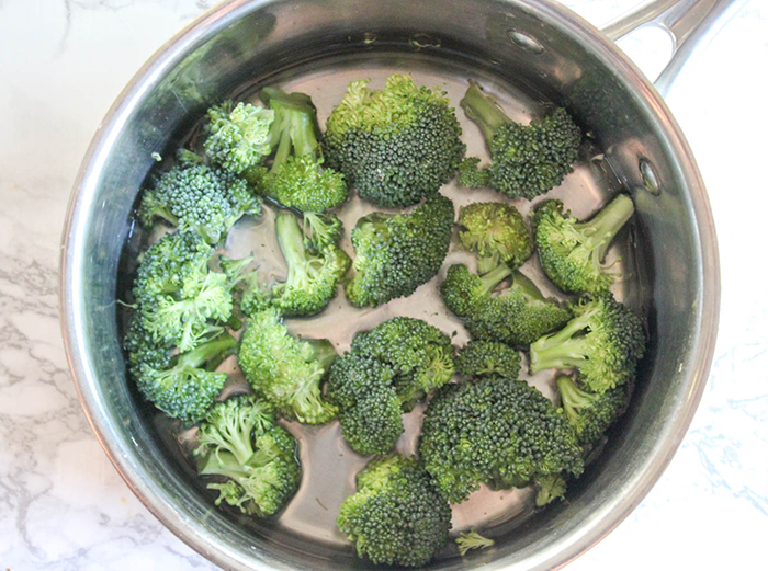 a saucepan with broccoli in it