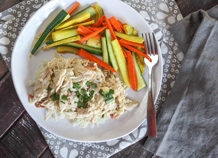 crack chicken on a plate with strips of zucchini and carrots