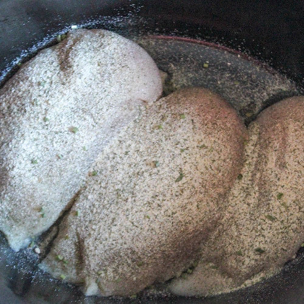 CRACK CHICKEN  step 1 chicken breasts in a crockpot with ranch seasoning blend on them