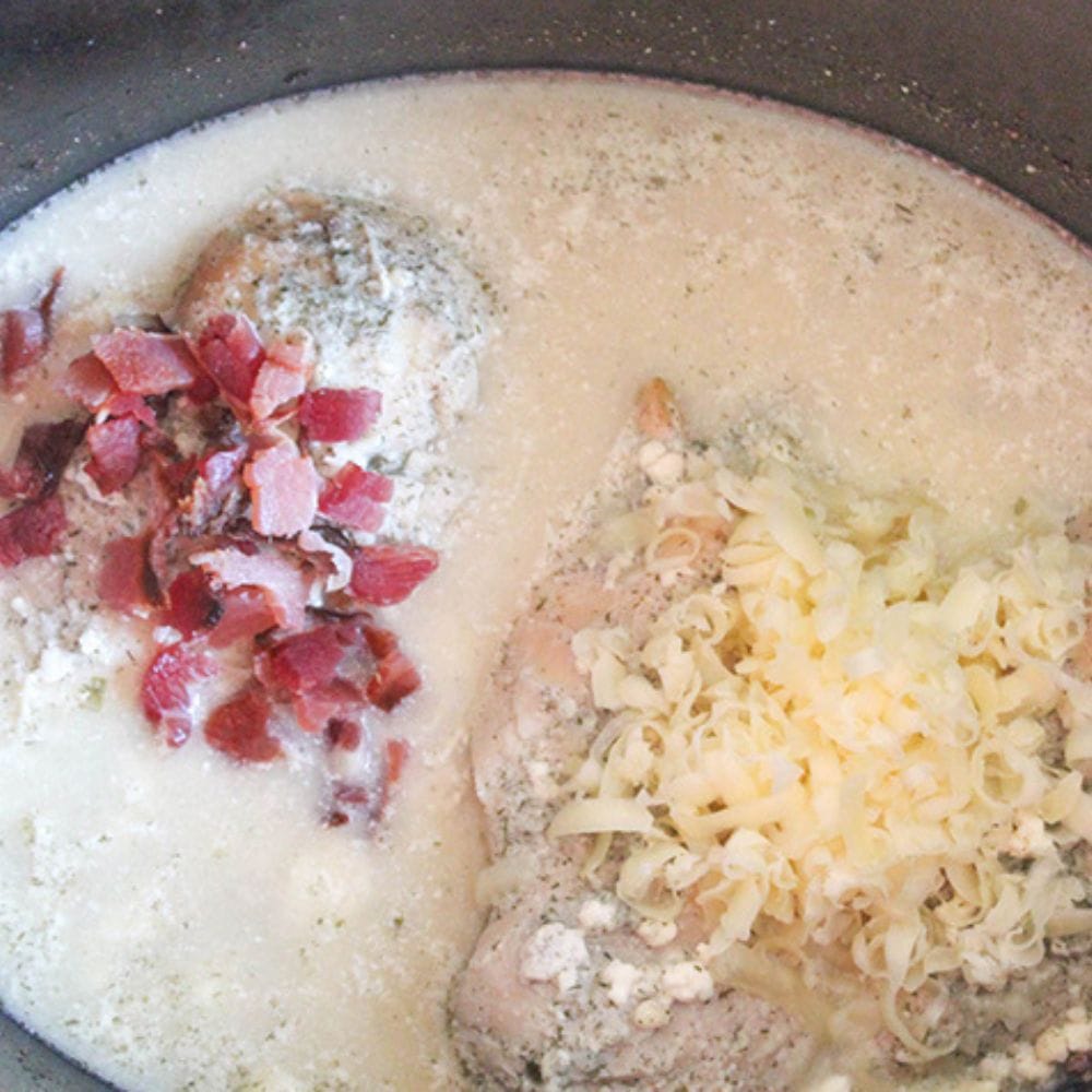 crack chicken process step3, cheese and bacon added to creamy sauce with cooked chicken