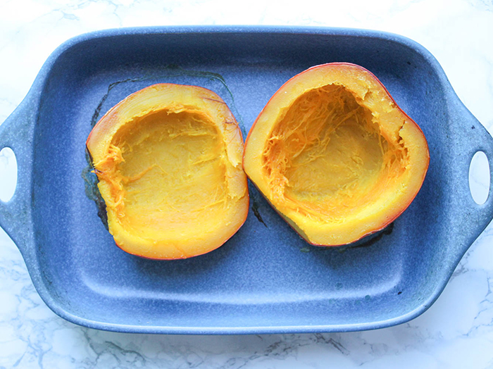 halves of pumpkin roasted in a roasting pan