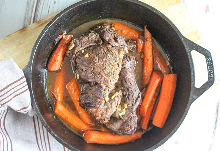 a picture of chuckroast coooked in pan with carrots
