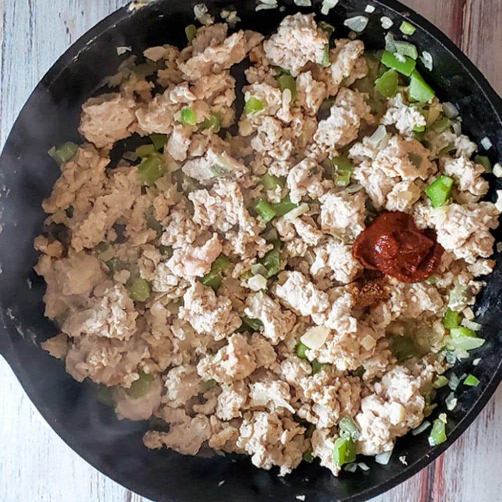 Process step cooked ground chicken with pepers, and adobo sauce