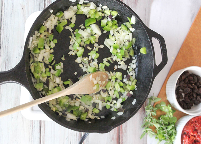 bell peppers, onions and garlic cooking in a skillet