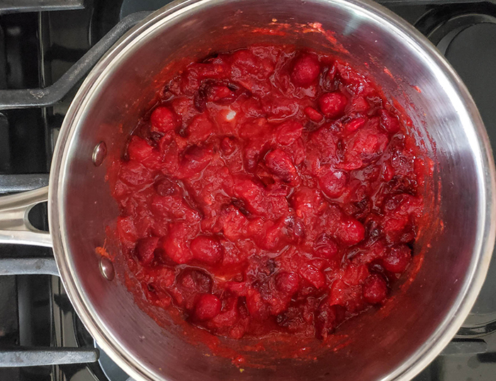 smashed cranberries cooking in a pan