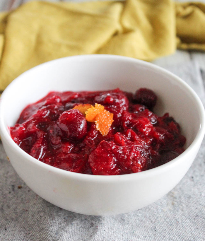 a close up of homemade cranberry sauce in a white bowl