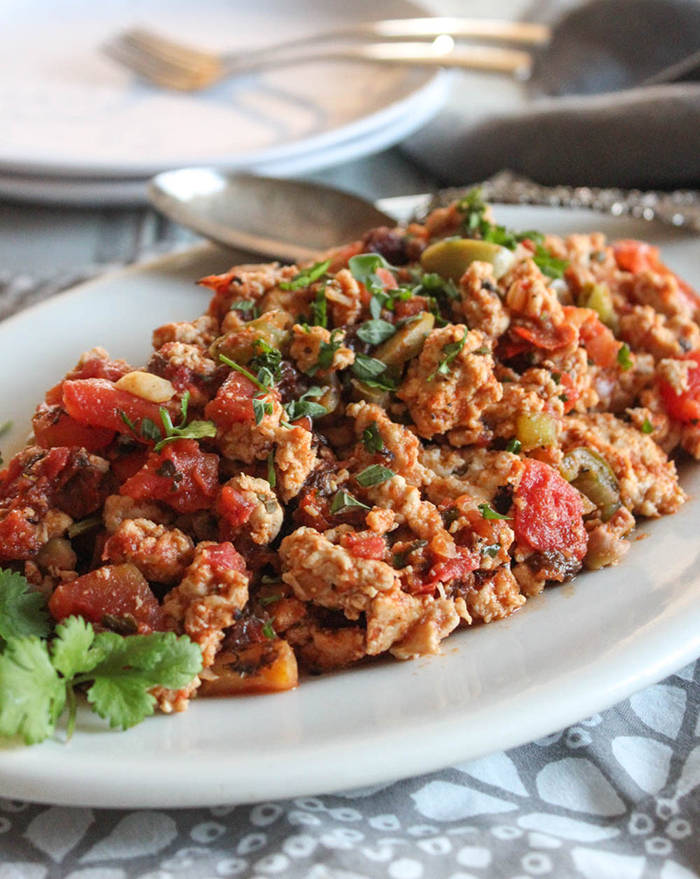 chicken picadillo on a plate with a spoon