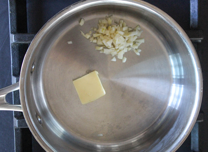 butter and garlic in a saucepan on a stove