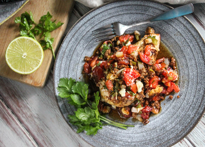 An Overhead view of the salsa chicken and sausage on a plae