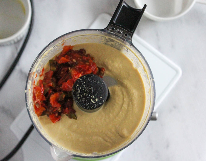 the cashew cream with tomaotes on top in a food processor