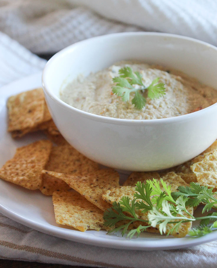 vegan queso dip in a bowl with cilantro on top