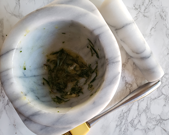 fresh rosemary, garlic and oil in a bowl