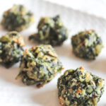baked spinach balls on a tray