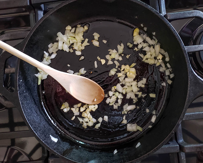 onions and garlic cooking in a skillet