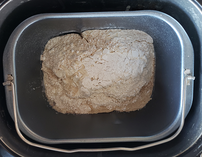 an overhead view of the ingredients in the bowl of a bread machine