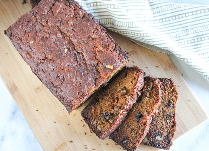 an overhead shot of persimmon bread sliced on a cutting board