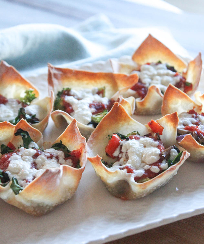 a close up of veggie lovers wonton pizza bites on a white plate