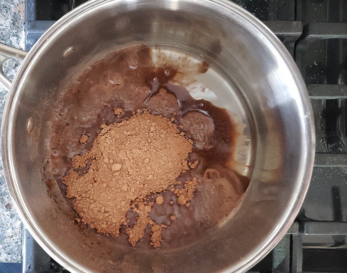 cocoa powder and coconut oil in a saucepan 