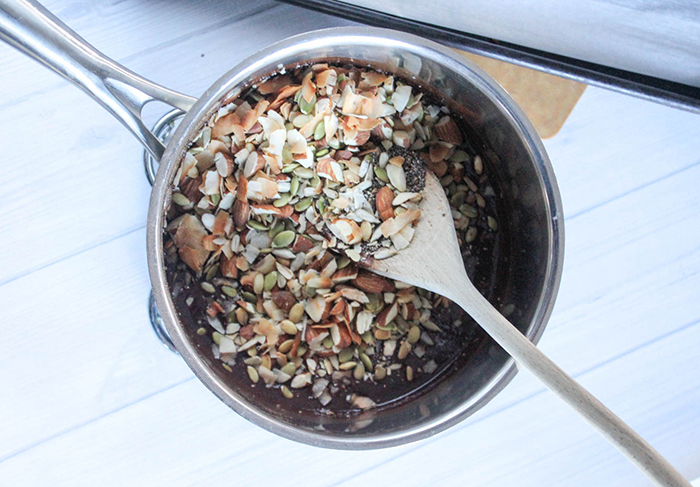 nuts and seeds added to pot of chocolate