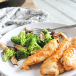 healthy orange chicken on a plate with broccoli and mushrooms