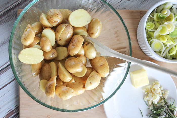 uncooked potatoes in a bowl with a spoon 