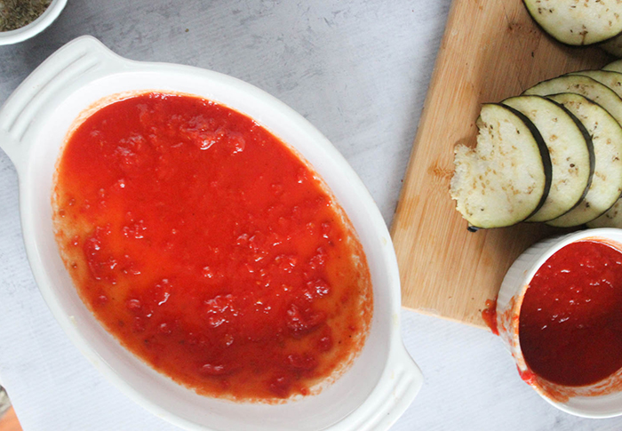 an overhead view of tomato sauce in a casserole dish