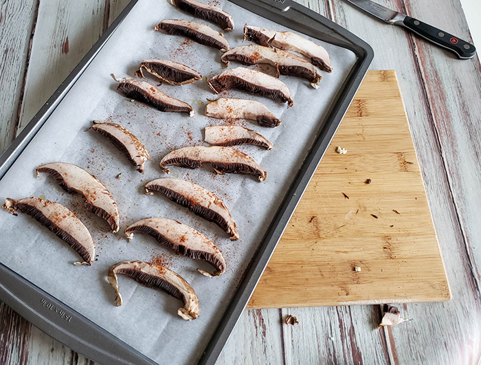 sliced portobello mushrooms on a baking tray