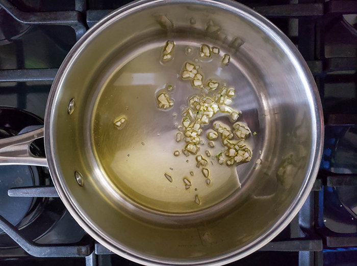 oil and garlic cooking in a pan