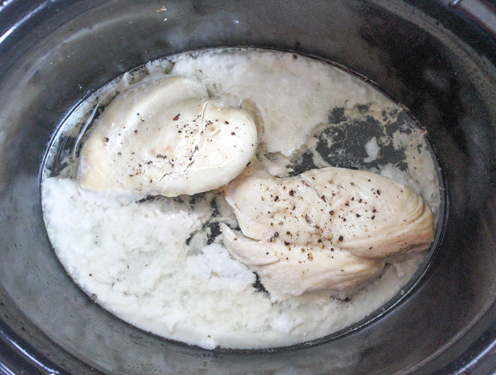 cooked chicken breasts in a crock pot