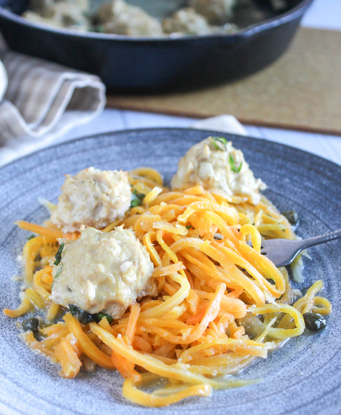 three chicken meatballs on a plate with butternut squash noodles