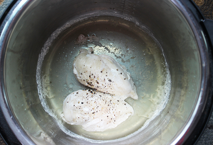 two cooked chicken breasts in an instant pot