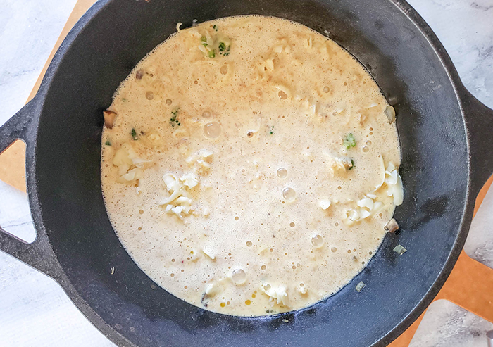 all of the uncooked ingredients in a skillet ready for the oven