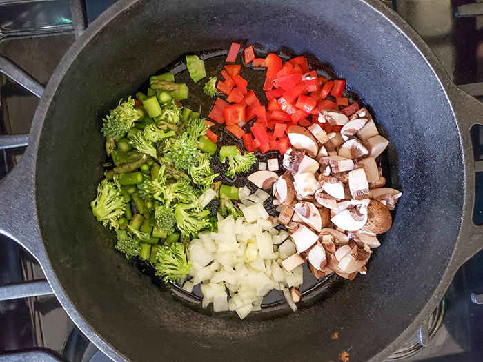 Chopped vegetables in a skillet (broccoli, asparagus, onions, mushrooms and red bell peppers)