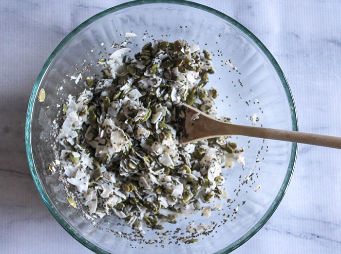 a picture of the ingredients for the coconut clusters in a mixing bowl all mixed up