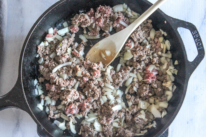 Process step 2: ground beef cooking with onions in a skillet