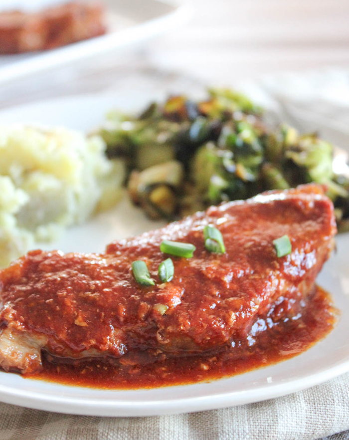 a close up of a boneless pork chop on a plate 