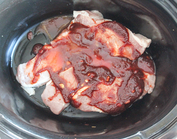 boneless pork chops in slow cooker with sauce on top