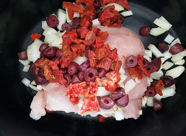 chicken breasts covered with sun dried tomatoes, onions, olives and garlic 