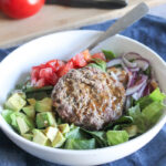 burger in a bowl on top of lettuce with a fork
