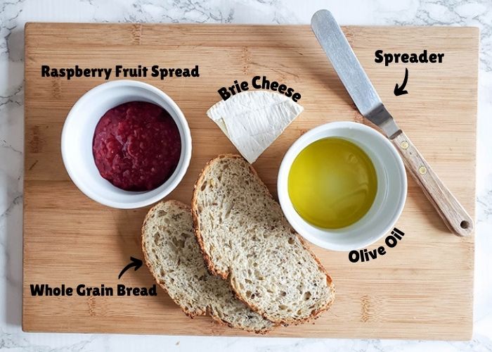 Grilled cheese ingredients: bread, raspberry spread, cheese and oil