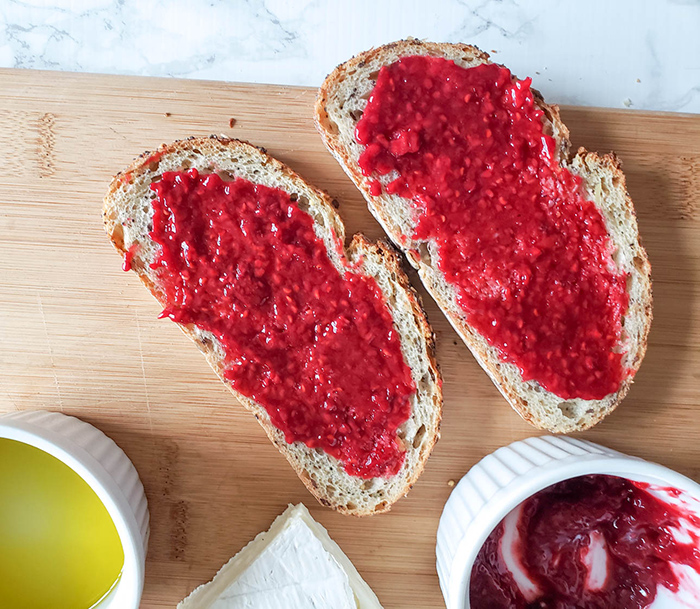 two slices of bread with raspberry jam on them